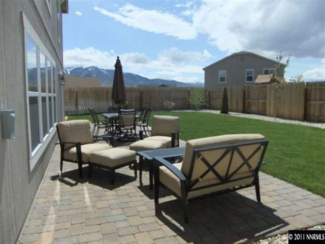 8967 Grisom Way Reno, NV 89506 - Photo 2 of 12 a view of a patio with a table chairs and a fire pit