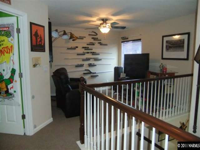 8967 Grisom Way Reno, NV 89506 - Photo 7 of 12 a view of a hallway with wooden floor and windows