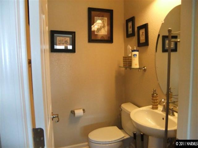 8967 Grisom Way Reno, NV 89506 - Photo 9 of 12 a bathroom with a toilet sink and mirror