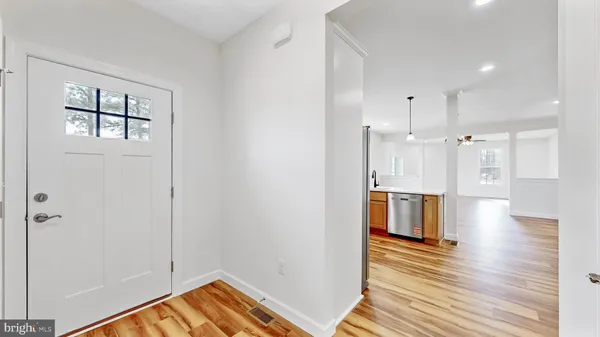 a view of empty room with wooden floor