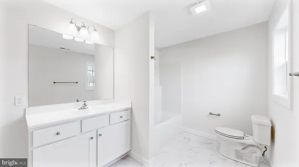 a front view of a house with a yard covered with snow in front of it