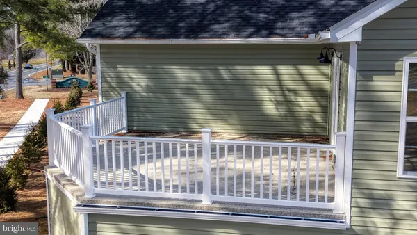 a view of a house with a porch and furniture