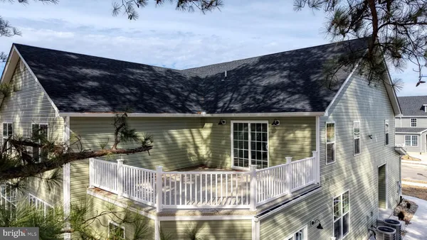 a view of a house with a wooden fence