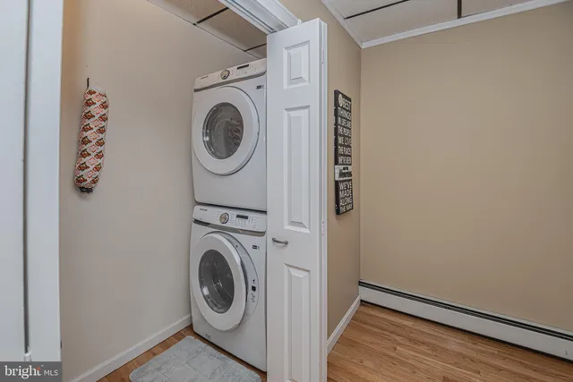 a bedroom with a bed and a flat tv screen on the dresser