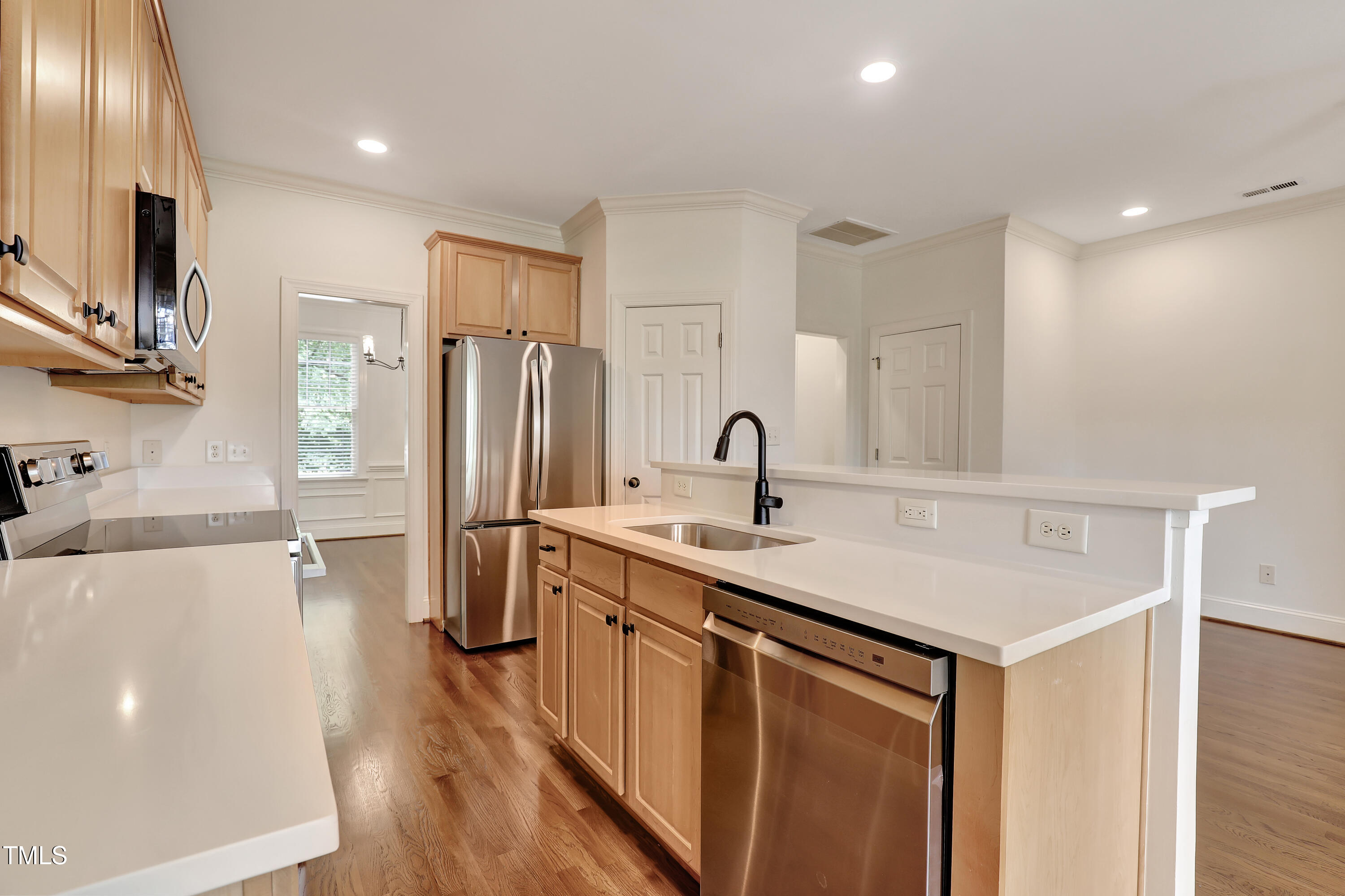 814 Cotton Exchange Court Raleigh, NC 27608 - Photo 13 of 35 a kitchen with stainless steel appliances a sink and a refrigerator