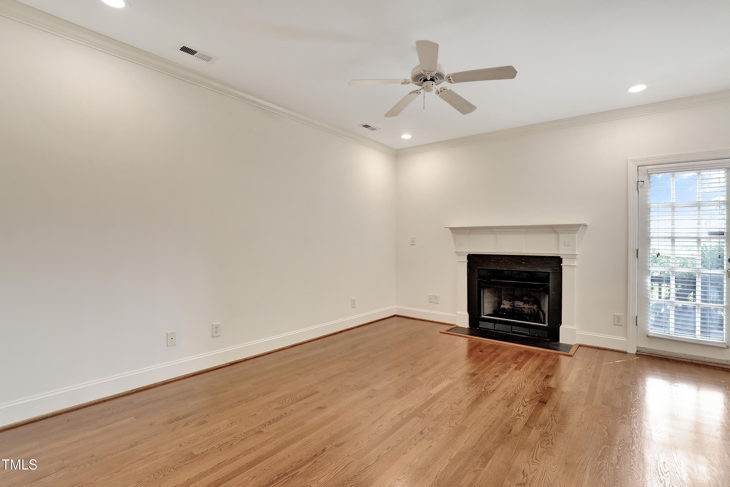 814 Cotton Exchange Court Raleigh, NC 27608 - Photo 15 of 35 an empty room with windows fireplace and a sink