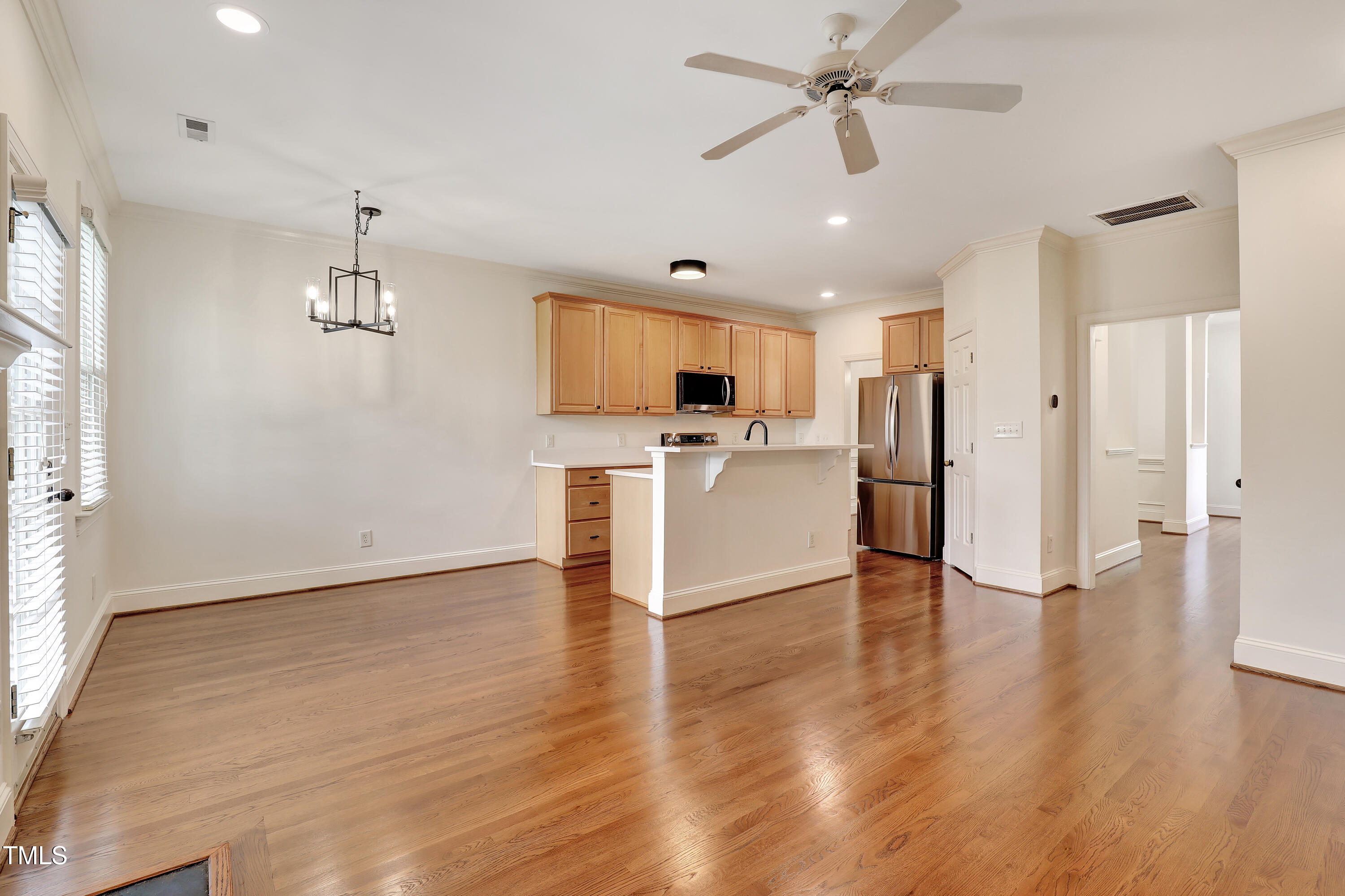 814 Cotton Exchange Court Raleigh, NC 27608 - Photo 16 of 35 a view of kitchen with refrigerator microwave and stove top oven