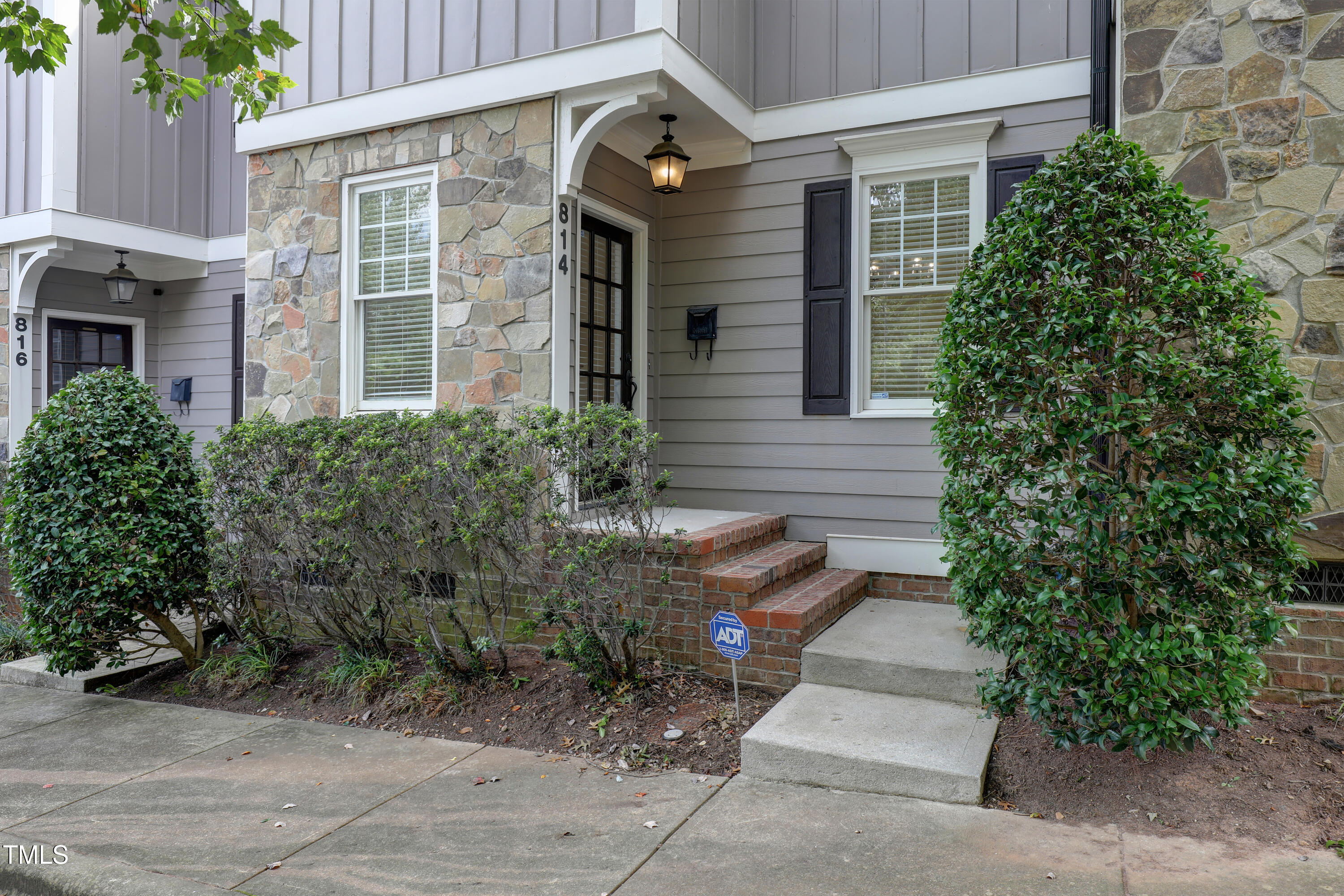 814 Cotton Exchange Court Raleigh, NC 27608 - Photo 2 of 35 a front view of a house with a garden