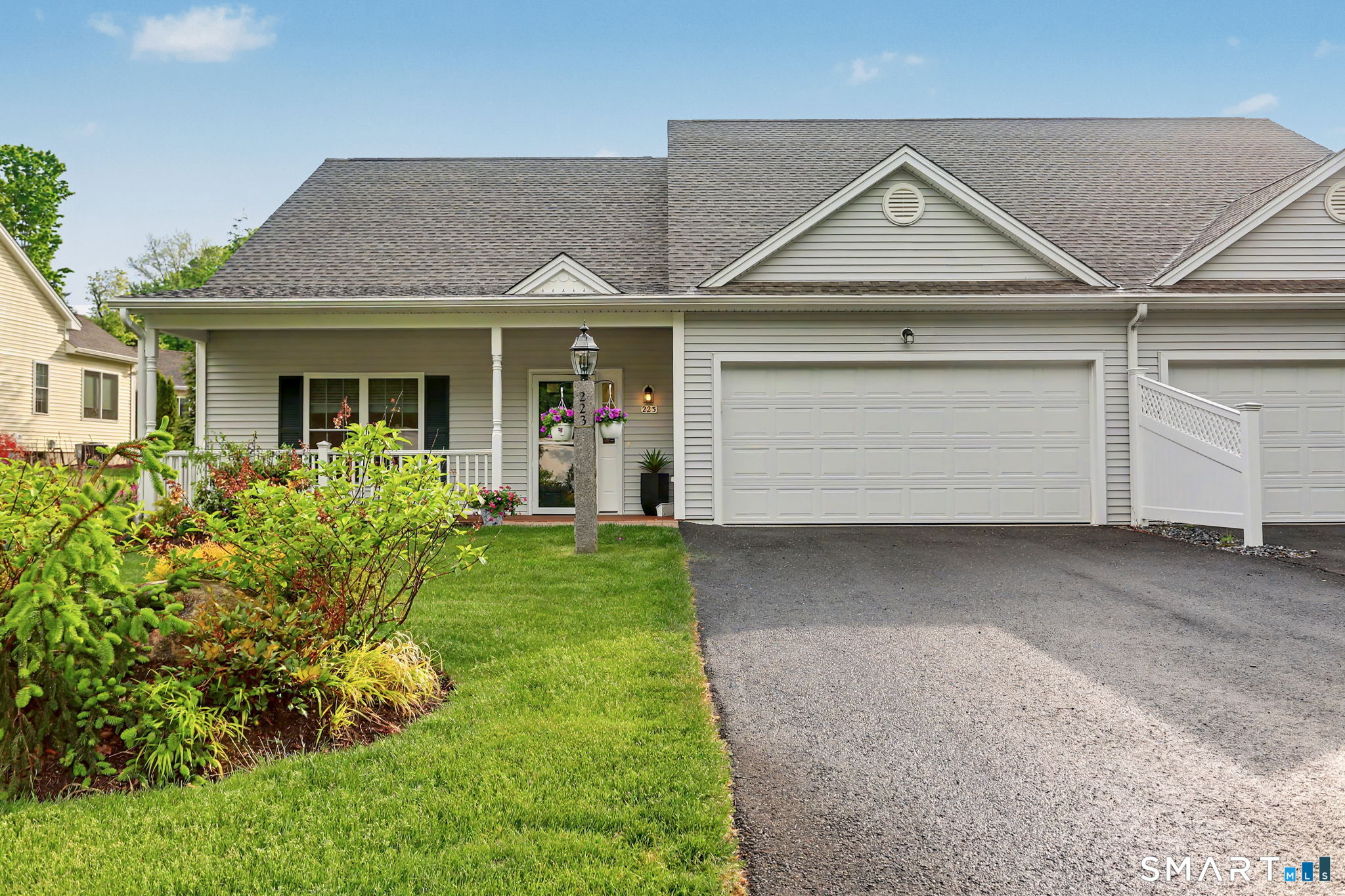 223 Meadow Brook Road, Unit 223 Oxford, CT 06478 - Photo 24 of 34 a front view of a house with a yard and garage