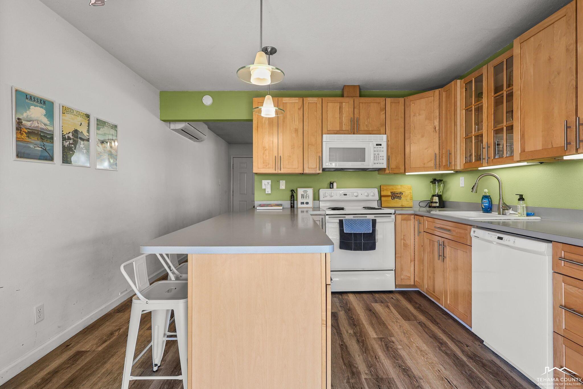 22275 Brent Road Red Bluff, CA 96080 - Photo 12 of 47 a kitchen with stainless steel appliances granite countertop a stove a refrigerator a sink dishwasher and white cabinets with wooden floor