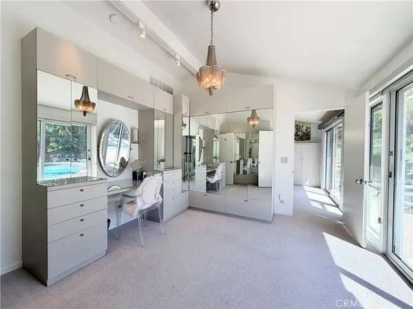 a bathroom with a granite countertop shower a toilet and a sink