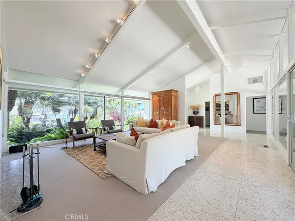 a living room with furniture a fireplace and a large window