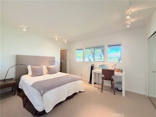 a spacious bedroom with a bed and window