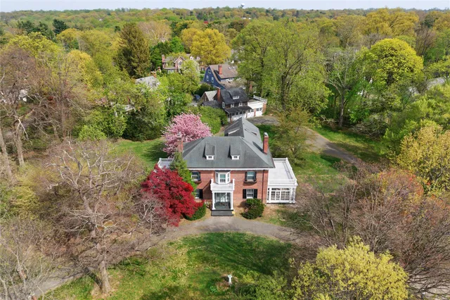 an aerial view of a house with a yard