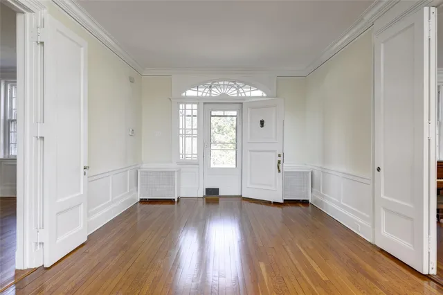 a view of entryway and hall with wooden floor