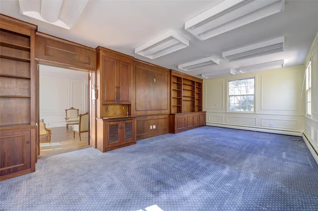 a living room with furniture a fireplace and a chandelier