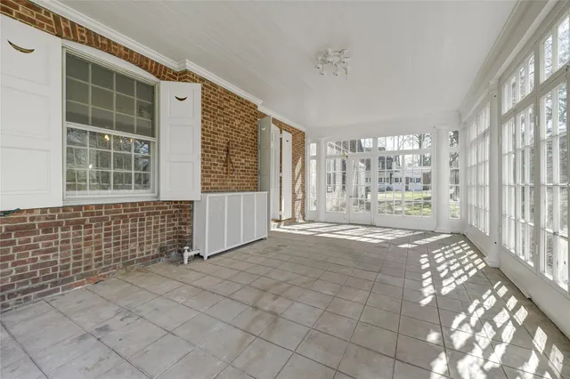 a view of hall with wooden floor and a fireplace