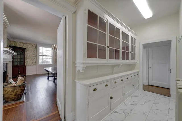 a kitchen with stainless steel appliances a dining table and chairs