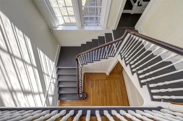 a view of hallway with wooden floor and chandelier