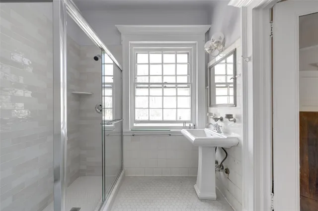 a view of a bedroom with furniture and window