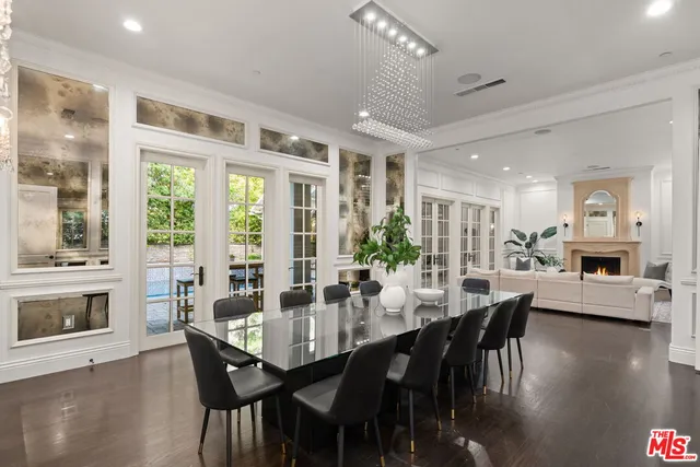 a living room with furniture and a painting on the wall
