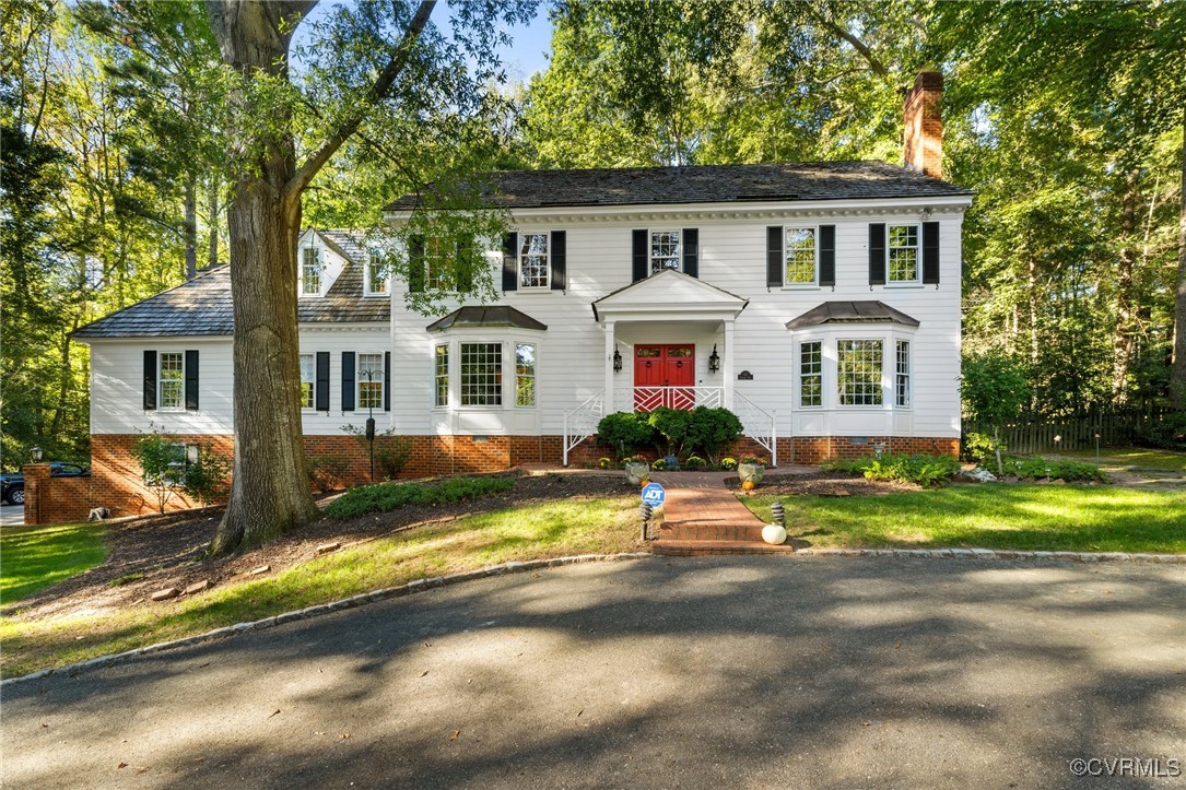 17 Dahlgren Road Richmond, VA 23238 - Photo 1 of 49 a view of a white house with a large windows and a big yard and large trees