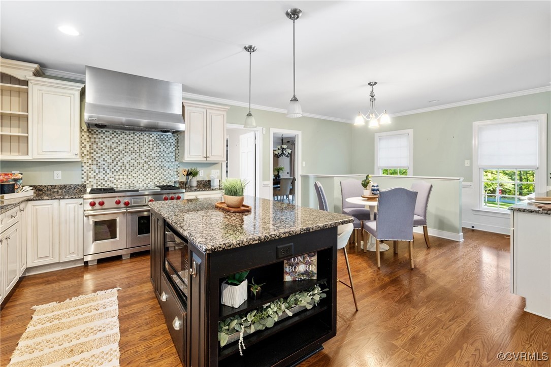 17 Dahlgren Road Richmond, VA 23238 - Photo 18 of 49 a open kitchen with stainless steel appliances granite countertop a stove a refrigerator a kitchen island a dining table and chairs with wooden floor