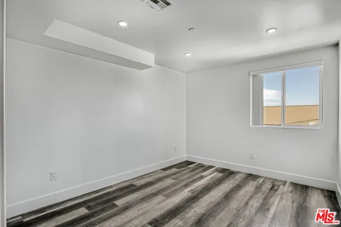 a view of a room with wooden floor