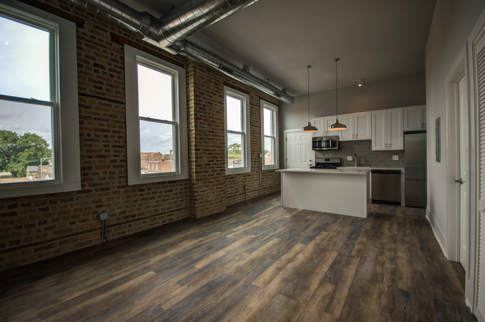 2115 South Wood Street, Unit 2S Chicago, IL 60608 - Photo 2 of 9 a kitchen with stove cabinets and wooden floor