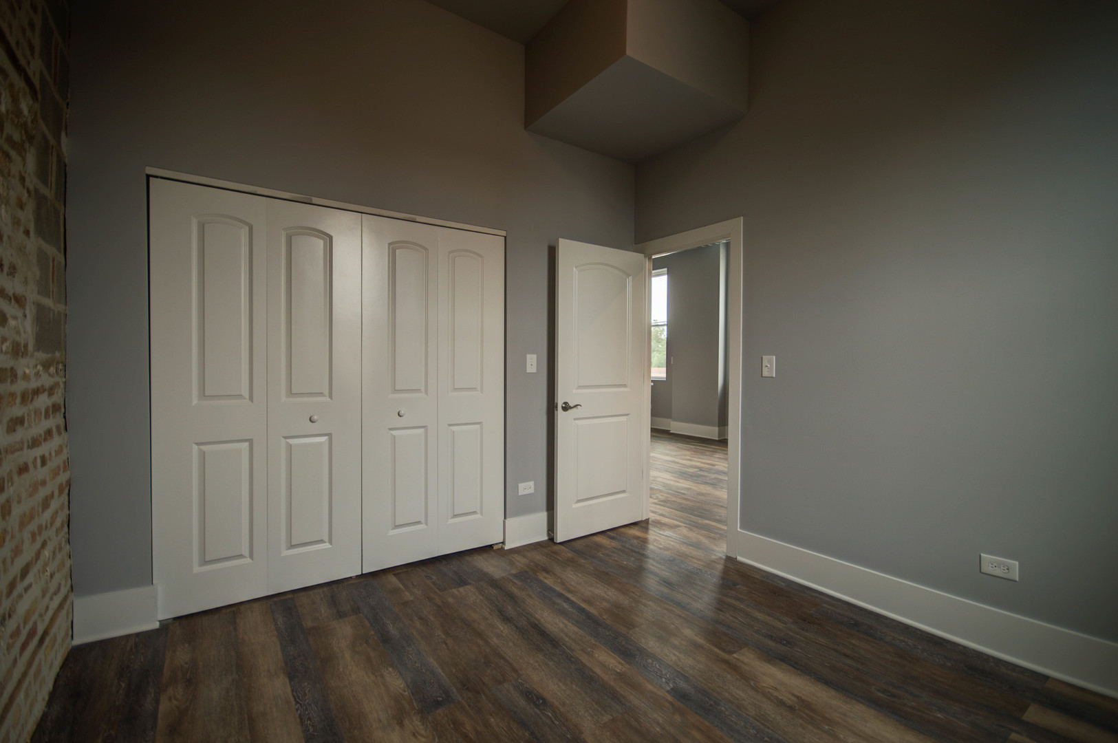 2115 South Wood Street, Unit 2S Chicago, IL 60608 - Photo 5 of 9 a view of a hallway with wooden floor