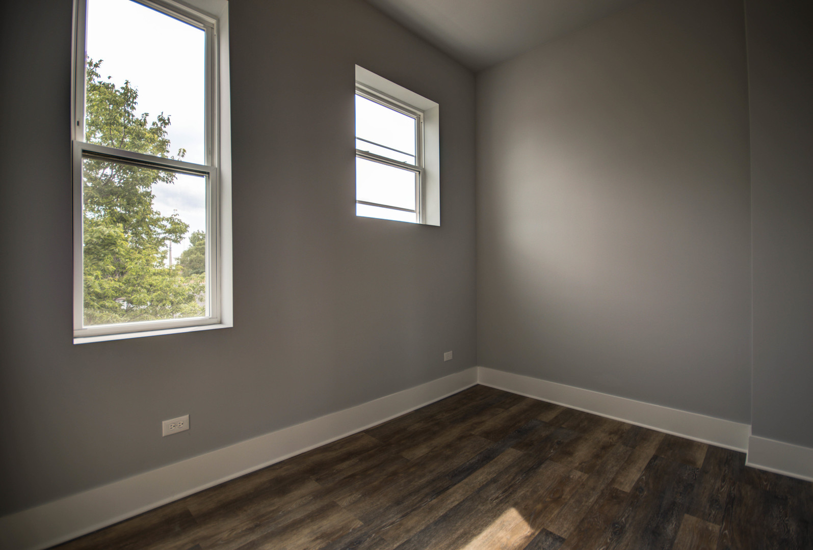 2115 South Wood Street, Unit 2S Chicago, IL 60608 - Photo 6 of 9 an empty room with wooden floor and windows