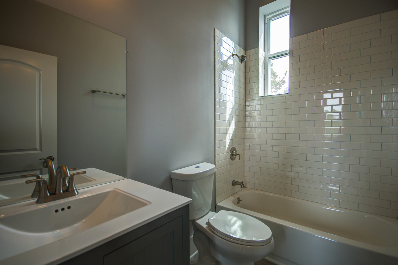 2115 South Wood Street, Unit 2S Chicago, IL 60608 - Photo 8 of 9 a bathroom with a sink a toilet and shower