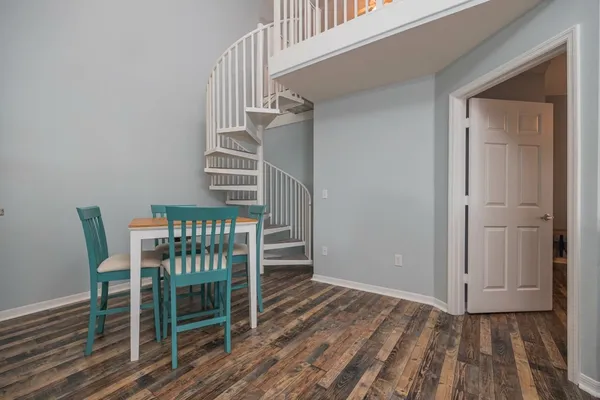 a view of a room with wooden floor and stairs