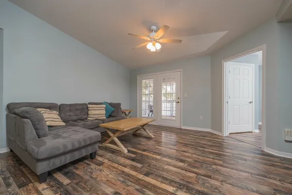 a living room with a couch and chandelier