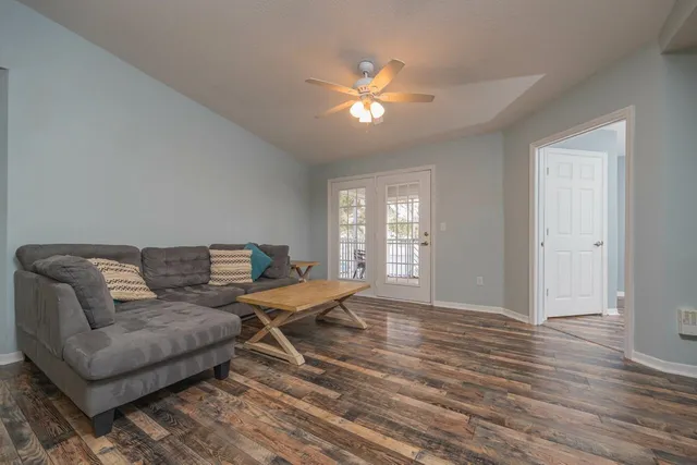 a living room with a couch and chandelier