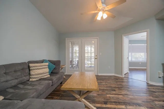 a living room with furniture and a chandelier