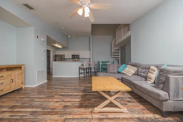 a living room with furniture and kitchen view