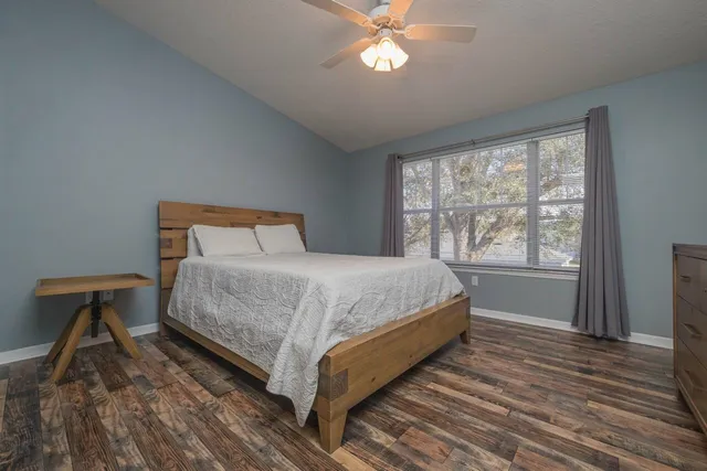 a bedroom with a bed and wooden floor