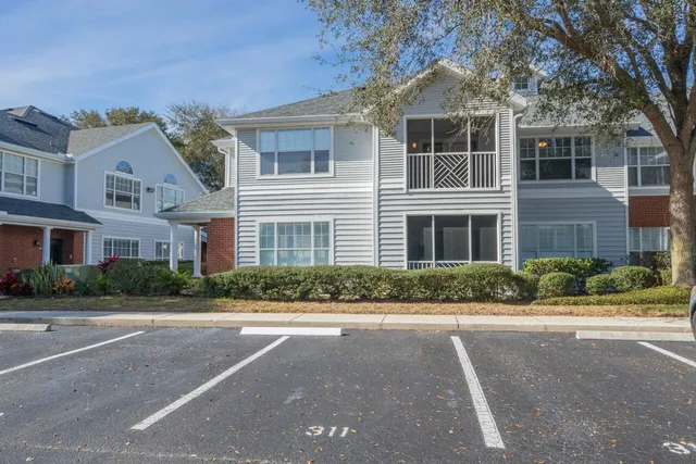 a front view of a brick house with a yard