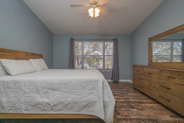 a bedroom with a large bed and a window