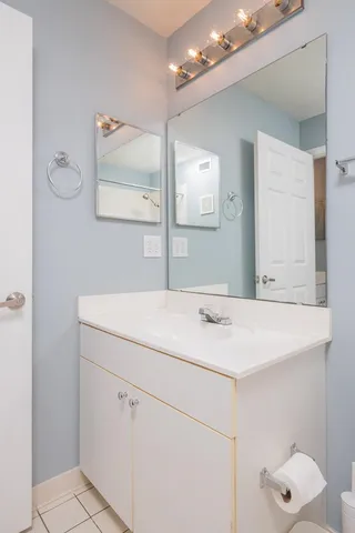 a bathroom with a sink vanity and mirror