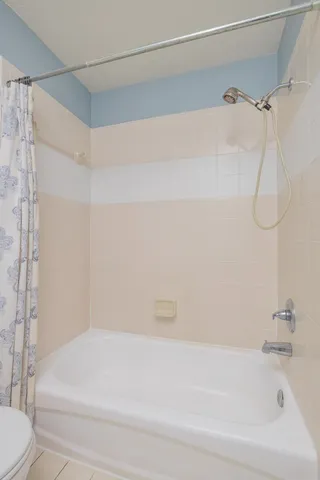 a bathroom with a shower and a toilet