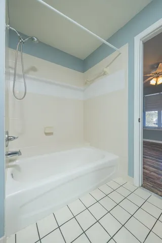 a spacious bathroom with a bathtub and a shower