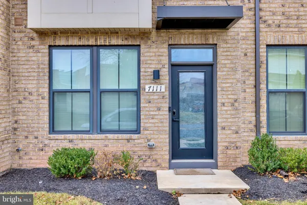 a kitchen with stainless steel appliances kitchen island granite countertop a kitchen island hardwood floor sink and stove