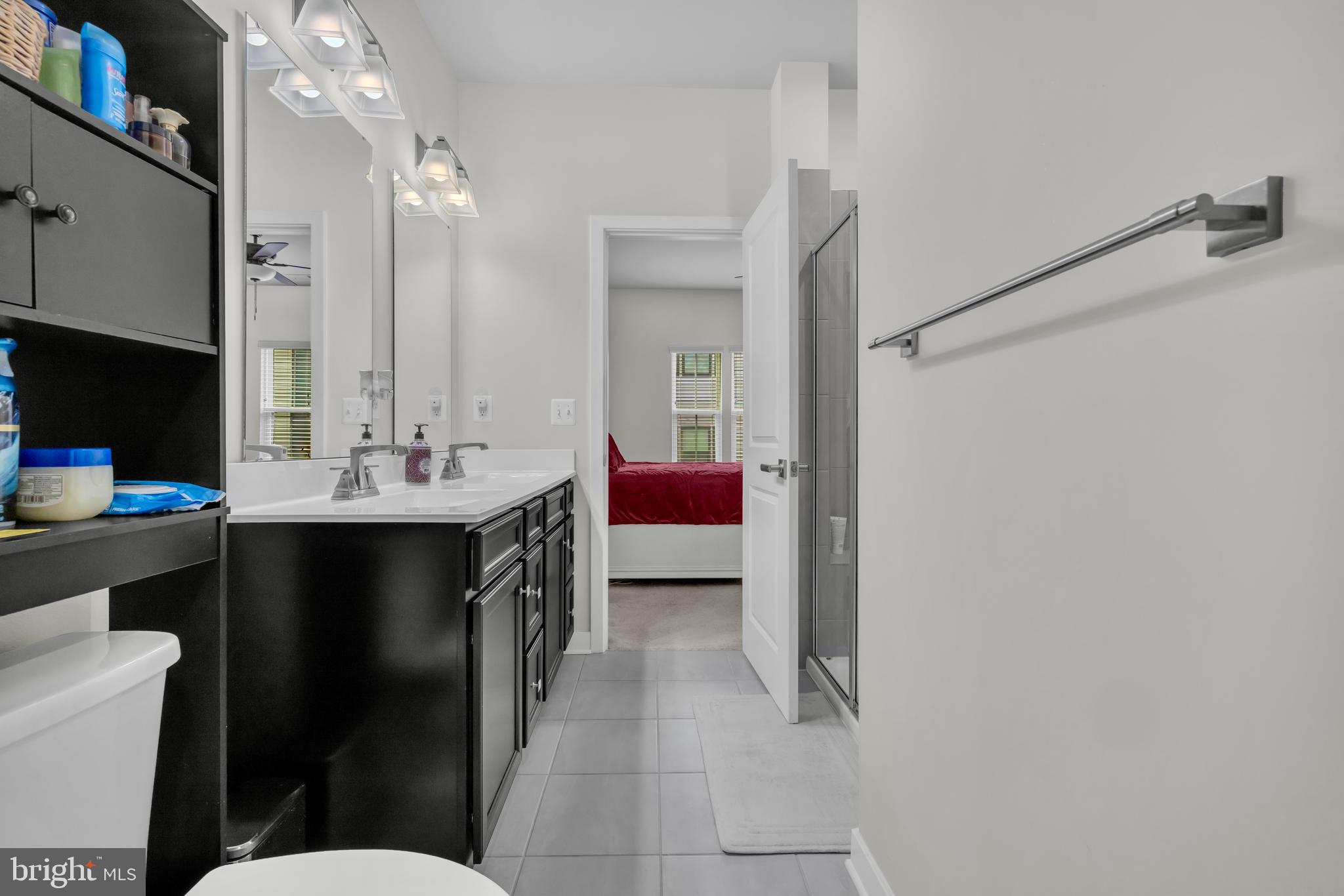 7111 Sollers Point Road Baltimore, MD 21222 - Photo 16 of 61 a en suite bathroom with a double vanity sink and a mirror