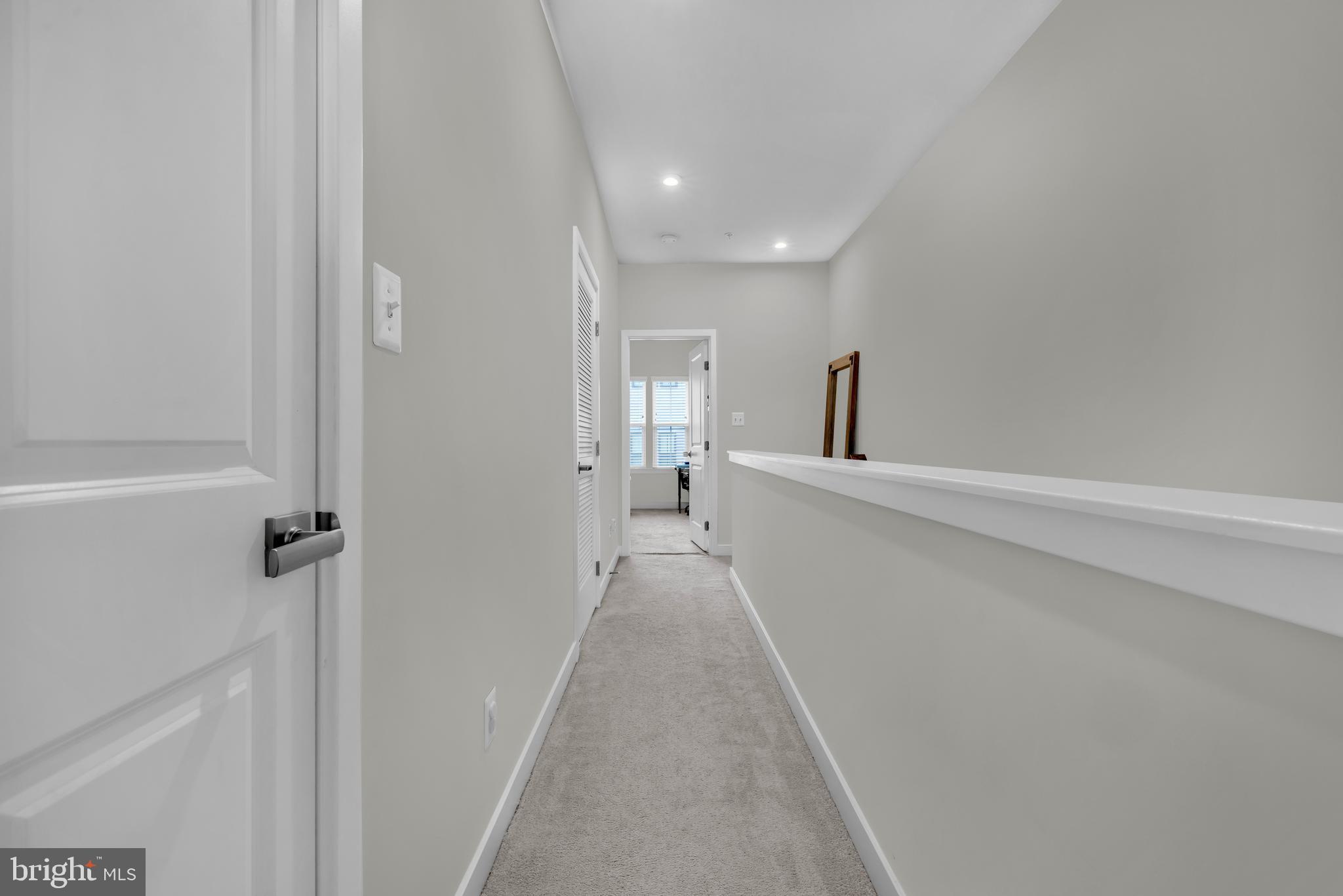 7111 Sollers Point Road Baltimore, MD 21222 - Photo 20 of 61 a view of a hallway with wooden floor and a bathroom