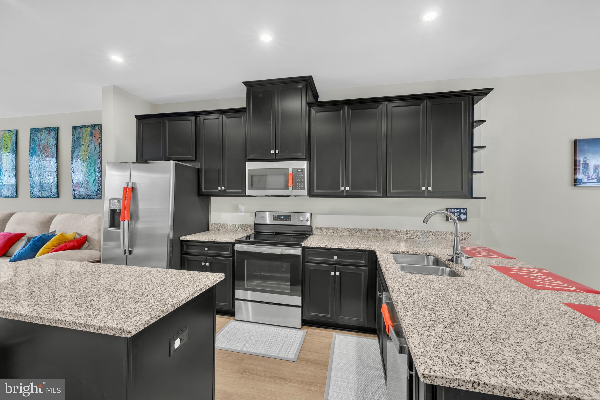 7111 Sollers Point Road Baltimore, MD 21222 - Photo 2 of 61 a kitchen with stainless steel appliances kitchen island granite countertop a kitchen island hardwood floor sink and stove