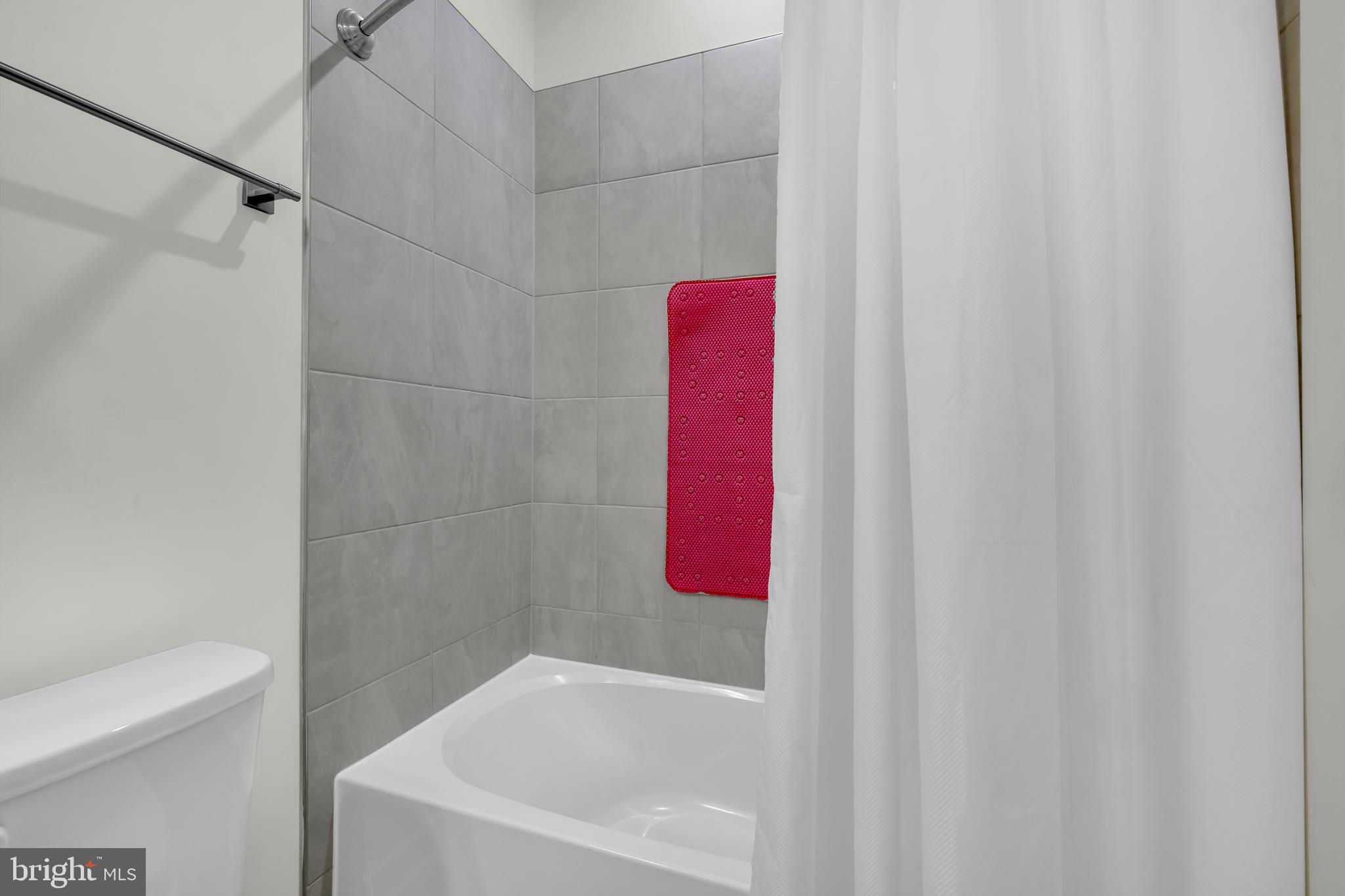 7111 Sollers Point Road Baltimore, MD 21222 - Photo 21 of 61 a bathroom with a bathtub and shower