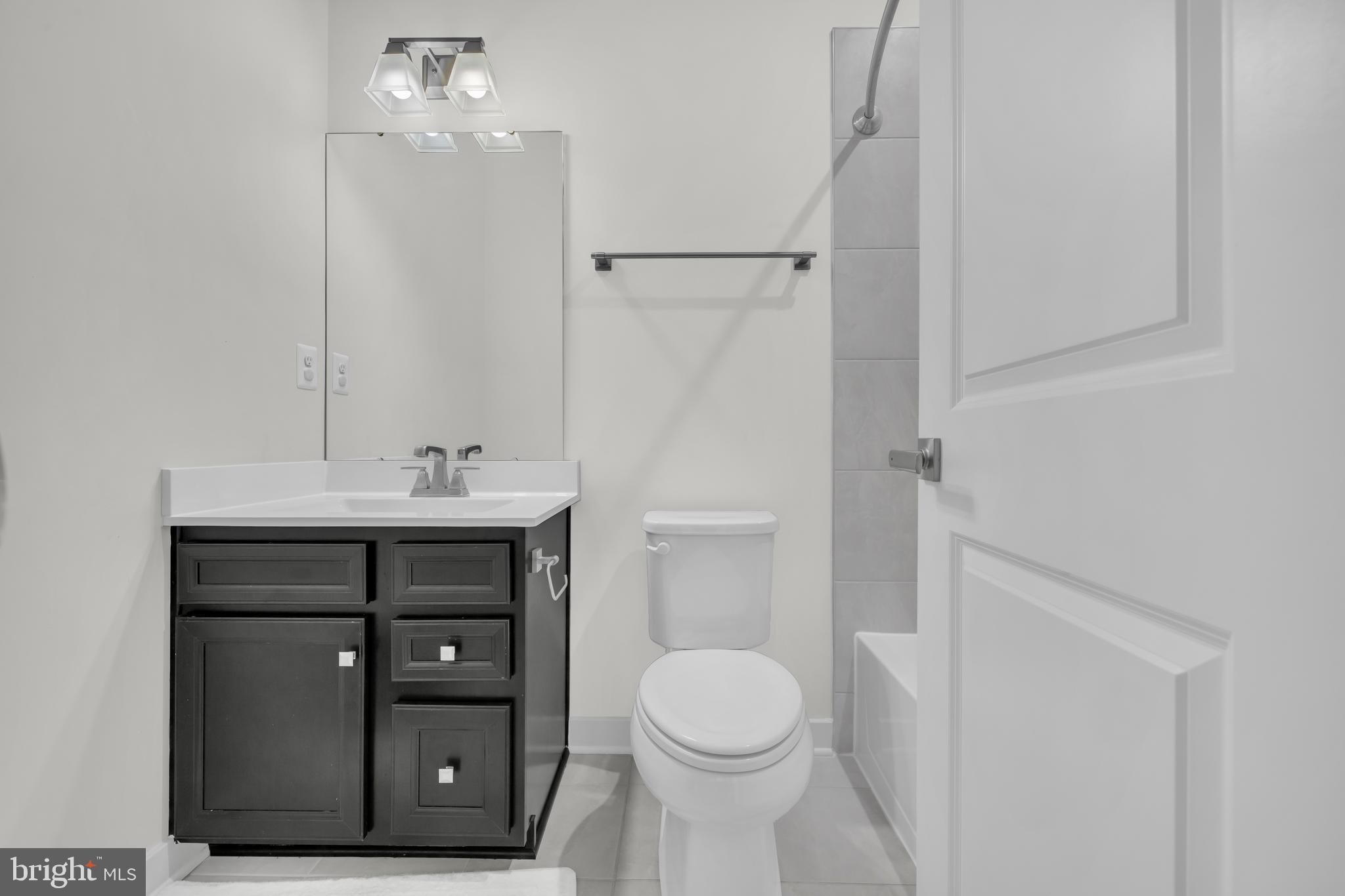 7111 Sollers Point Road Baltimore, MD 21222 - Photo 23 of 61 a bathroom with a sink a toilet and shower