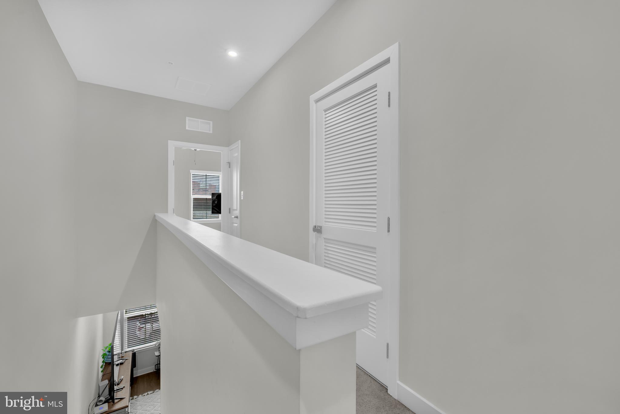 7111 Sollers Point Road Baltimore, MD 21222 - Photo 28 of 61 a hallway with white cabinets and wooden floor